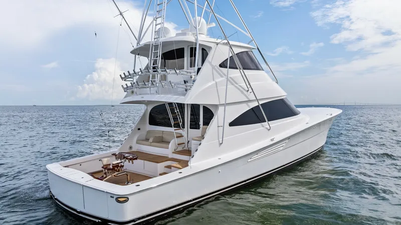 Slide: The Image of Aft Deck and Tower View This image showcases the elegant aft deck of the 2021 Viking 72 Enclosed Bridge, featuring a spacious cockpit designed for both relaxation and sportfishing. The sleek, modern lines of the enclosed bridge complement the vessel's robust tower, providing exc - 7377957