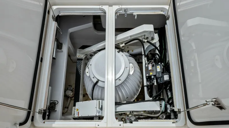 Slide: The Image of Engine Compartment Access Hatch This image showcases the neatly arranged engine compartment of the 2021 Viking 72 Enclosed Bridge. The compartment features a clean and well-organized layout with easy access for maintenance. The high-quality components and precise engineering are evident - 7377950