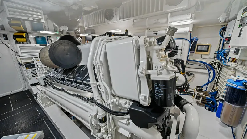 Slide: The Image of Engine Room with Advanced Systems The engine room of the 2021 Viking 72 Enclosed Bridge showcases a powerful and meticulously maintained propulsion system. Featuring cutting-edge technology and organized layout, it provides easy access to all critical components. The clean and well-lit sp - 7377932