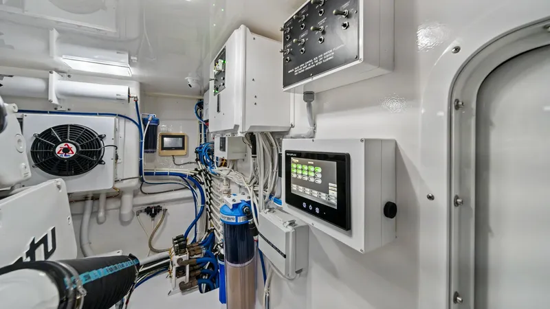 Slide: The Image of Engine Room Control Panel This image showcases the sophisticated engine room of the 2021 Viking 72 Enclosed Bridge. The space is equipped with state-of-the-art control panels and monitoring systems, ensuring efficient operation and safety. The clean, organized layout and high-qual - 7377933