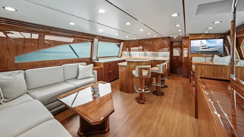 Slide: The Image of Spacious Interior Salon This elegant interior salon of the 2021 Viking 72 Enclosed Bridge offers a luxurious and inviting space. It features plush seating, a polished wood finish, and modern lighting that enhance the upscale ambiance. Large windows provide panoramic views, creat - 7377875