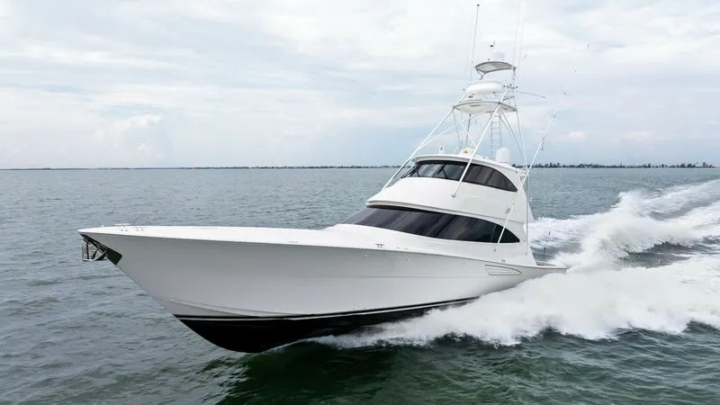 Slide: The Image of Viking 72 Enclosed Bridge Cruising This image showcases the sleek and powerful design of the 2021 Viking 72 Enclosed Bridge as it glides effortlessly through the water. The sharp, aerodynamic lines of the hull and the enclosed bridge provide both style and functionality, ensuring a command - 7377964