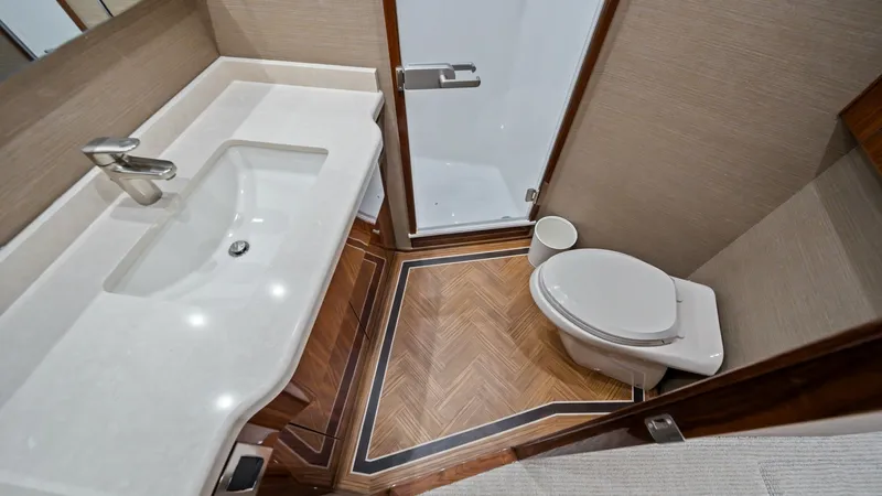 Slide: The Image of Guest Head with Shower This stylish guest head features a sleek vanity with a modern sink and polished chrome fixtures. The wooden flooring adds warmth and elegance, while the enclosed shower offers privacy and convenience. Meticulously designed, this space combines functionali - 7377908