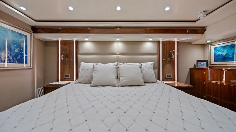Slide: The Image of Luxurious Master Stateroom Interior The master stateroom of the 2021 Viking 72 Enclosed Bridge offers a serene and elegant retreat. It features a plush, king-sized bed with premium bedding, surrounded by rich wood finishes and subtle, ambient lighting. Carefully selected artworks and ample - 7377910