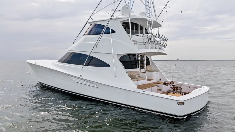 Slide: The Image of Aft Deck and Enclosed Bridge This image showcases the sleek aft deck of the 2021 Viking 72 Enclosed Bridge, featuring ample seating for relaxation and entertaining. The design highlights a beautifully integrated fishing cockpit, ideal for avid anglers. The enclosed bridge offers a co - 7377958