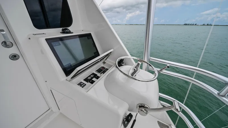 Slide: The Image of Flybridge Helm Station The flybridge helm station on the 2021 Viking 72 Enclosed Bridge offers a commanding view of the surrounding waters. Featuring state-of-the-art navigation equipment and a sleek, ergonomic design, this helm ensures ease of operation and comfort. The stainl - 7377881
