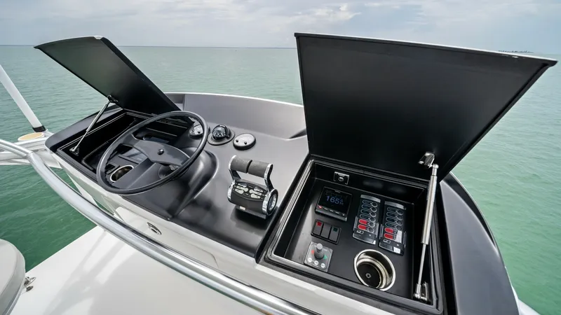 Slide: The Image of Flybridge Helm Station The flybridge helm station of the 2021 Viking 72 Enclosed Bridge offers a sleek and functional design. It features advanced navigation controls, including a precision steering wheel and clearly displayed instrumentation. The open layout provides an excell - 7377879