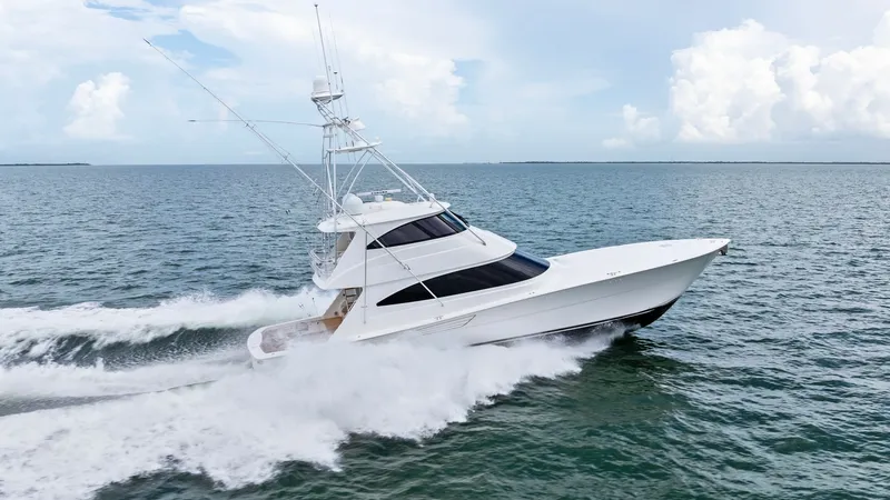 Slide: The Image of Dynamic Side View at Sea This 2021 Viking 72 Enclosed Bridge is shown cutting through the open waters with grace and power. The sleek, aerodynamic profile highlights its advanced hull design and robust construction, while the enclosed bridge offers enhanced visibility and comfort - 7377965
