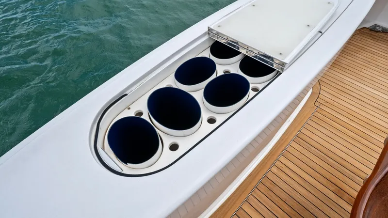 Slide: The Image of Deck Rod Holder Storage This image showcases the Viking 72 Enclosed Bridge's deck rod holder storage, designed for avid anglers. The well-organized compartment features multiple circular holders set into a sleek, streamlined surface, offering practical and efficient storage for - 7377948