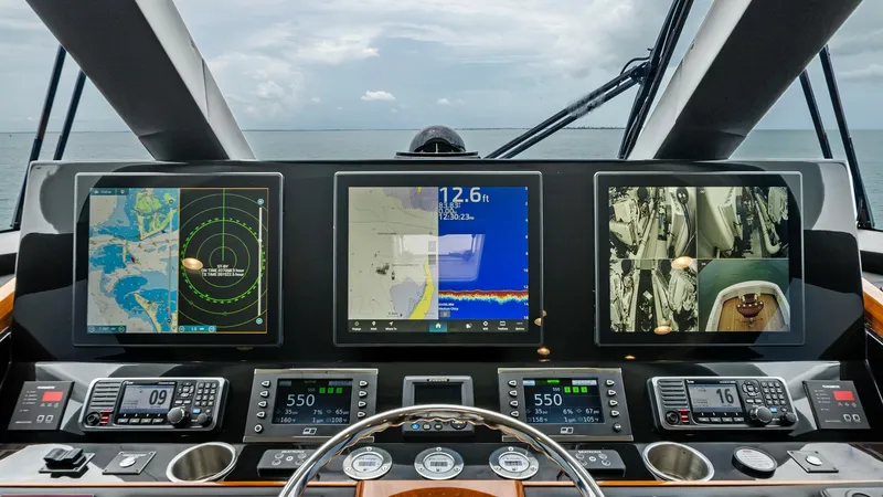 Slide: The Image of State-of-the-Art Helm Station The helm station of the 2021 Viking 72 Enclosed Bridge features advanced navigation and control systems. Multiple high-resolution displays provide comprehensive data, including radar, GPS, and engine metrics, all within easy reach for efficient operation. - 7377886