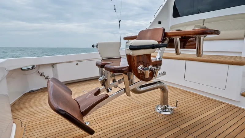 Slide: The Image of Teak Cockpit with Fighting Chair This impressive cockpit on the 2021 Viking 72 Enclosed Bridge features a finely crafted teak deck, enhancing its elegant and durable appeal. Central to the space is a premium fighting chair, designed for comfort and functionality, making it ideal for seri - 7377944