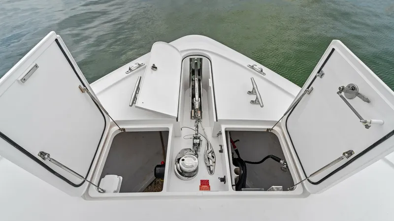 Slide: The Image of Bow Anchor Locker and Storage This image showcases the bow area of the 2021 Viking 72 Enclosed Bridge, featuring an organized anchor locker and storage compartments. The clean, white finish complements the robust build quality, while the accessible layout ensures practical utility for - 7377951