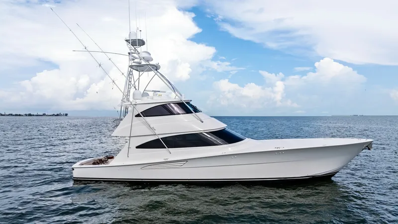 Slide: The Image of Starboard Profile of Viking 72 Enclosed Bridge This side view showcases the sleek and powerful design of the 2021 Viking 72 Enclosed Bridge. Its streamlined profile is accentuated by the elegant curvature of the hull and the expansive, tinted windows that promise panoramic views. The vessel's towering - 7377952