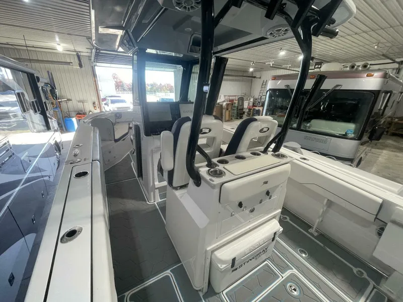 Slide: The Image of Center Console Cockpit Layout with Leaning Post and Helm Seating Spacious cockpit view showing dual helm seats, leaning post, and wide walkways. Clean deck layout designed for fishing or family cruising on a modern center console boat. - 5799736