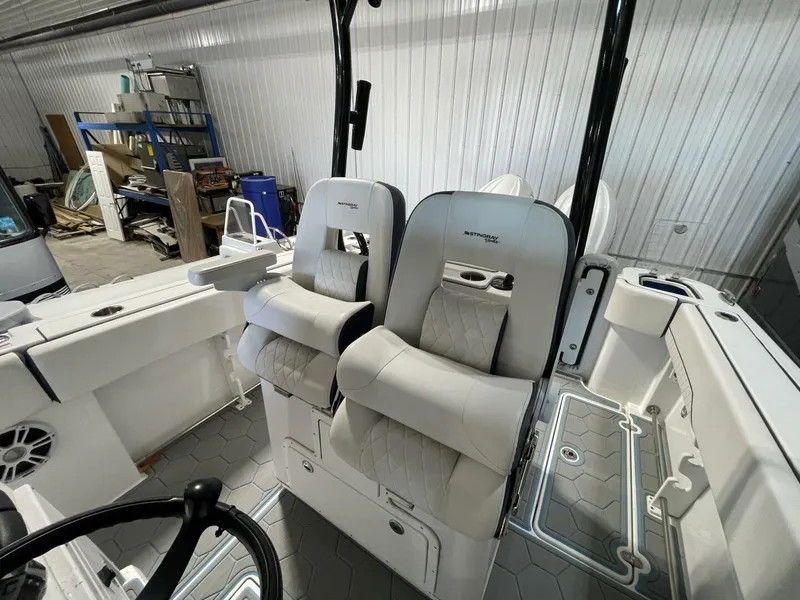 Slide: The Image of Premium Bolstered Helm Seats with Armrests on Center Console Boat Dual embroidered helm seats with diamond stitching, flip-up bolsters, and armrests. High-comfort seating for offshore cruising and fishing. - 5799727
