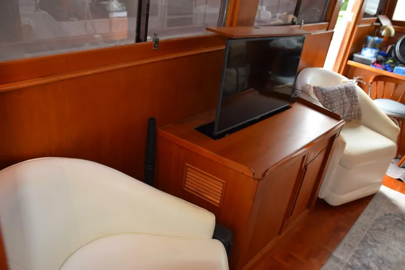Slide: The Image of Forward view of portside salon, TV and chairs. Pilothouse door open further forward. - 5805830