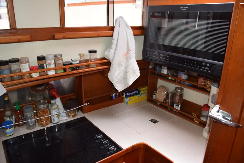 Slide: The Image of Updated galley with electric stovetop, microwave oven and spice shelves - 5805835