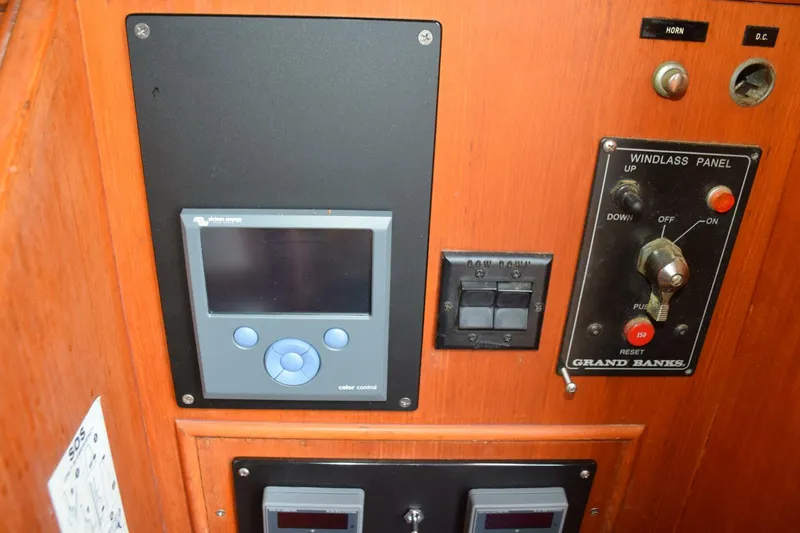 Slide: The Image of Inverter control display, trim tab rocker switches, and windlass control are to the side of the lower helm - 5805857