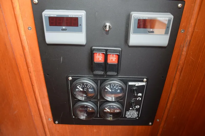 Slide: The Image of Battery charge level meters and generator control panel to the side of the lower helm - 5805858