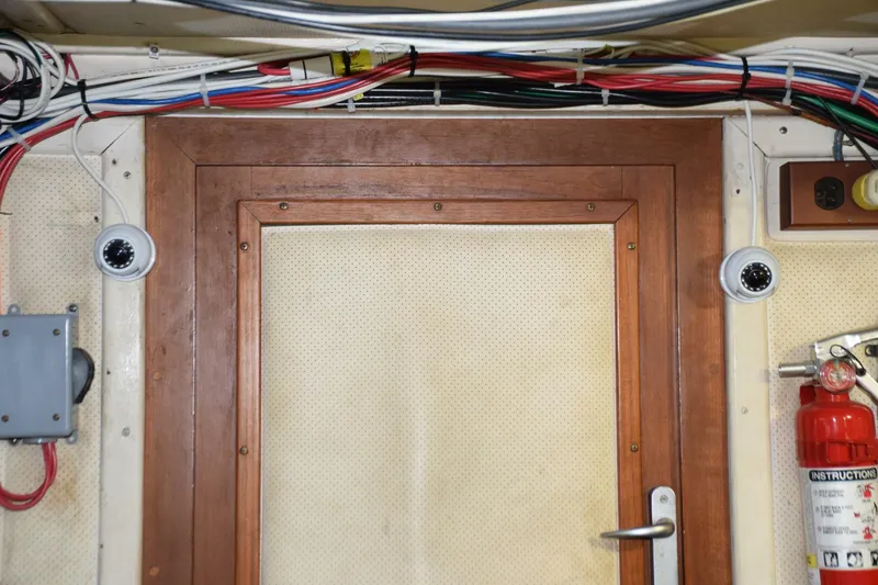 Slide: The Image of Door from engine room opens to forward companionway beneath steps - cameras mounted to either side which display on Furuno monitors - 5805904