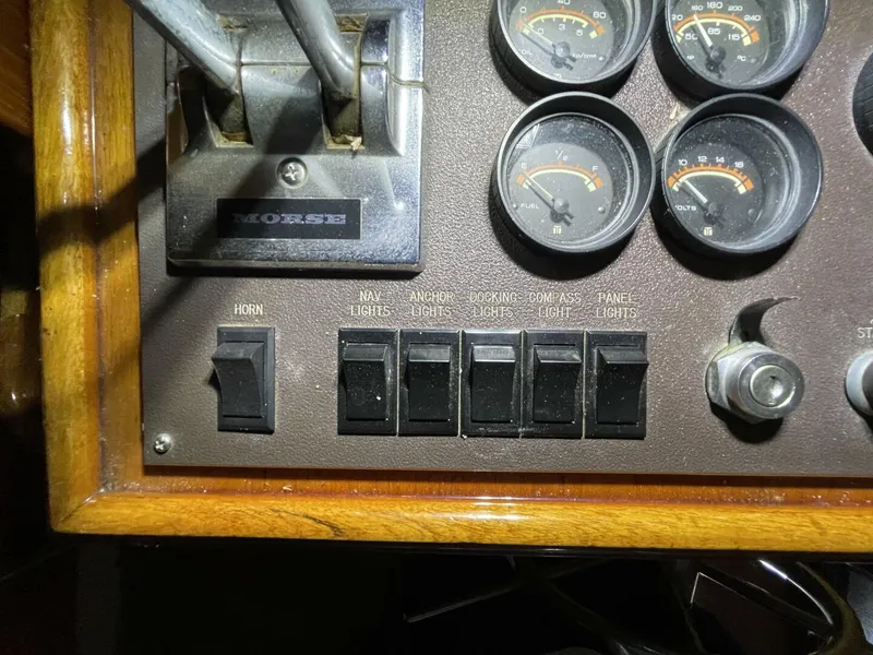 Slide: The Image of Helm Switch Panel with Lighting Controls – Egg Harbor 40 Motor Yacht Switch panel including horn, navigation lights, anchor light, docking lights, and panel lighting—clean and functional. - 5808856