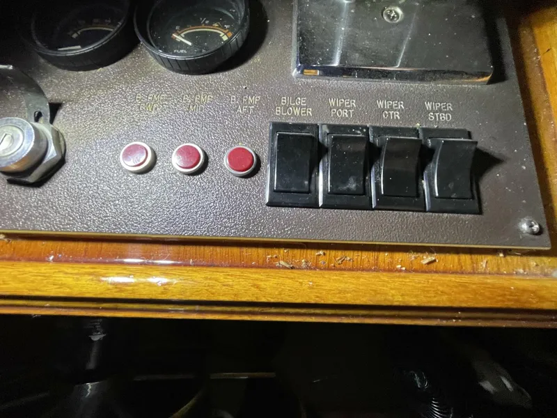 Slide: The Image of Helm Bilge and Wiper Control Panel – Egg Harbor 40 Bilge pump and blower buttons alongside port, center, and starboard wiper switches—clearly labeled and in good condition. - 5808854