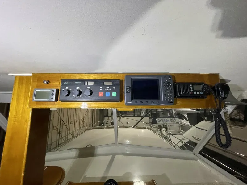 Slide: The Image of Forward View from Upper Helm – Egg Harbor 40 Motor Yacht Unobstructed forward sightline from the helm showcasing the bow area and surrounding boats inside covered storage. - 5808859