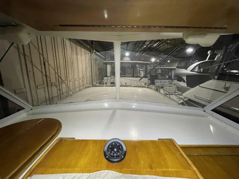 Slide: The Image of Overhead Electronics Panel at Helm – Egg Harbor 40 Motor Yacht Electronics pod including Garmin display, VHF radio, and autopilot controls mounted neatly above the helm. - 5808860