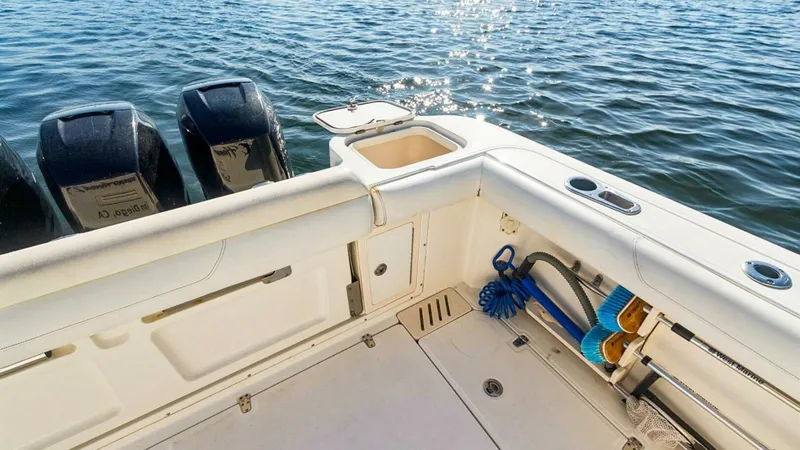 Slide: The Image of Aft Deck with Fishing Gear The aft deck of the 2008 Boston Whaler 34 Outrage, HAMMERHEAD II, showcases a well-organized space ideal for anglers. Equipped with rod holders and storage for fishing gear, this area is designed for convenience and efficiency. The sturdy construction and - 7672510