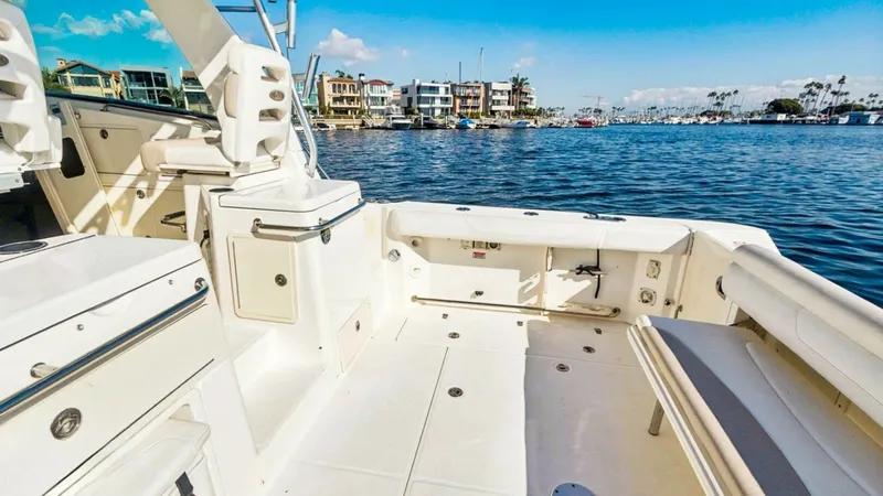 Slide: The Image of Spacious Aft Deck with Seating The aft deck of the 2008 Boston Whaler 34 Outrage offers ample space for relaxation and fishing activities. Featuring sturdy, built-in seating, this area provides a comfortable spot to enjoy the surrounding views. The deck's clean, white finish enhances t - 7672494