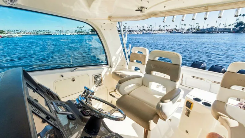 Slide: The Image of Helm with Dual Captain's Chairs The helm of the 2008 Boston Whaler 34 Outrage, 'HAMMERHEAD II', features dual plush captain's chairs for ultimate comfort and control. The dashboard is equipped with advanced navigation and control systems, offering a comprehensive view for seamless opera - 7672503