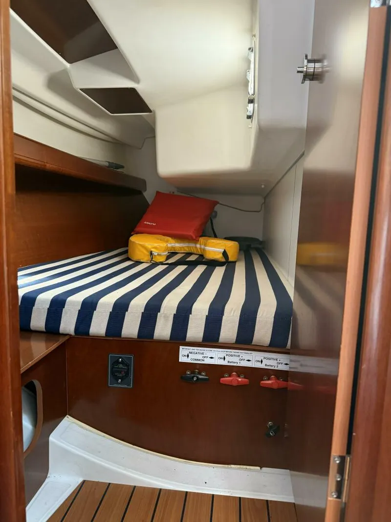 Slide: The Image of Starboard Aft Berth Single berth, hanging locker, shelves alongside hull and stowage space under berth - 5822394