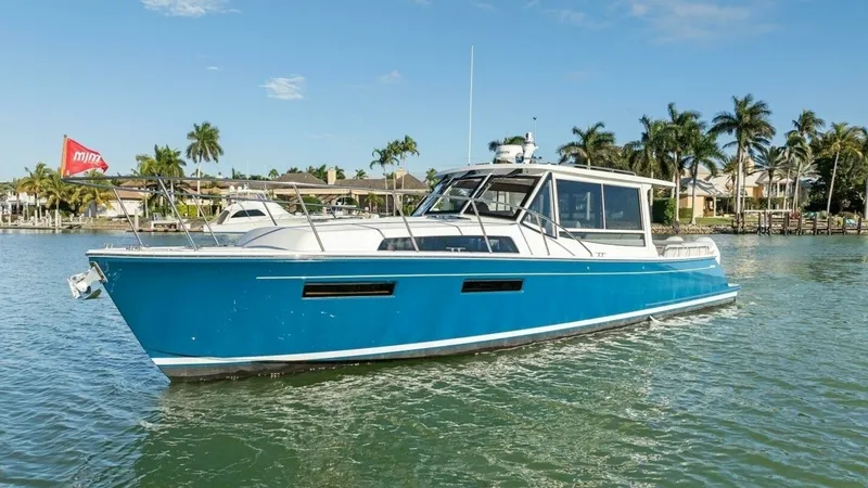 The Image of Starboard Bow View The 2026 MJM 47R showcases a sleek and modern design with its striking blue hull and streamlined profile. This starboard bow view highlights the elegant lines and spacious deck layout, perfect for both leisure cruising and entertaining. The large windows - 7089622