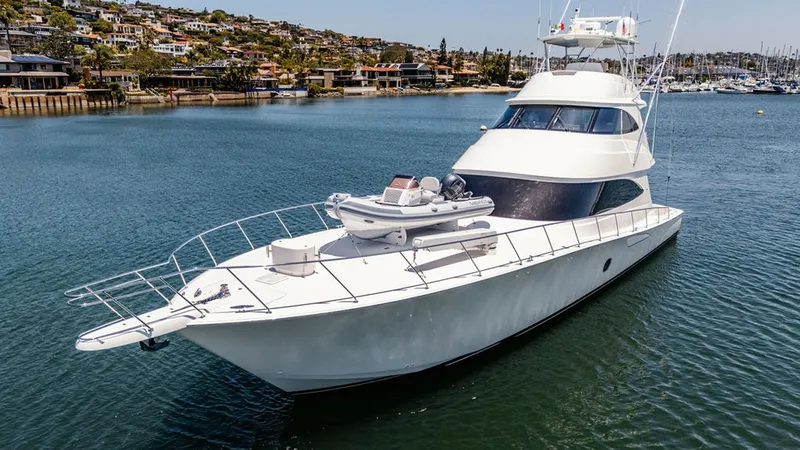 Slide: The Image of Bow View with Tender This image showcases the sleek bow of the 2019 Viking 80 Skybridge, featuring a spacious deck with a securely mounted tender. The streamlined design is complemented by polished stainless steel railings and a pristine white finish, offering both functional - 6478775