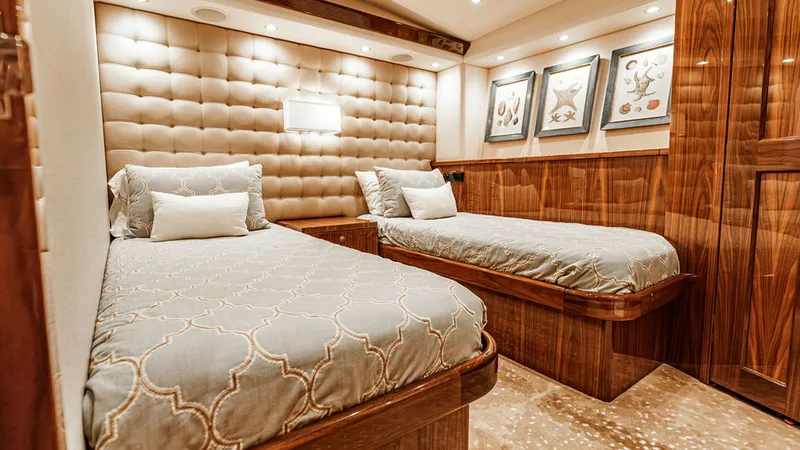 Slide: The Image of Guest Stateroom with Twin Beds This inviting guest stateroom features two comfortable twin beds, set against a luxurious padded headboard. Warm wood finishes and elegant artwork enhance the cozy ambiance, while recessed lighting adds a touch of modern elegance. The thoughtful layout en - 6478723