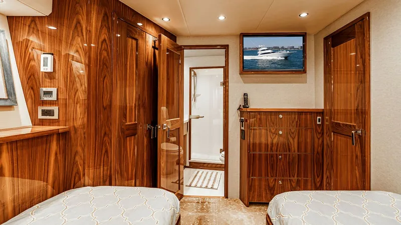 Slide: The Image of Guest Stateroom with Ensuite Bathroom This elegant guest stateroom features rich wood finishes and two twin beds, offering a luxurious and comfortable retreat. The room is equipped with modern amenities, including a wall-mounted TV and ample storage space. An ensuite bathroom adds convenience - 6478724