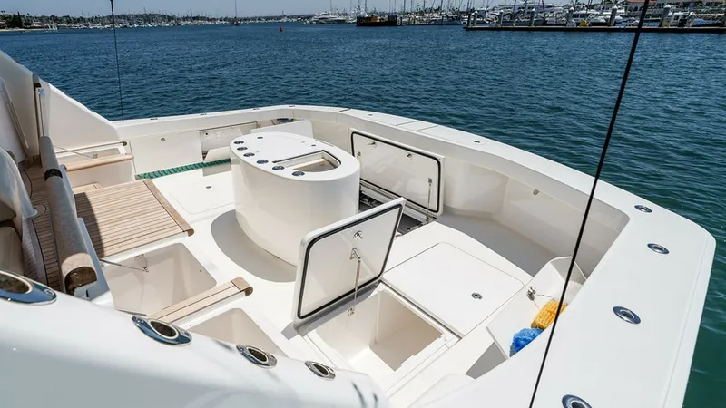 Slide: The Image of Spacious Aft Cockpit with Storage The aft cockpit of the 2019 Viking 80 Skybridge boasts ample space for fishing and relaxation. It features multiple storage compartments, ideal for organizing gear and supplies. The clean, sleek design with integrated seating and a central workstation enh - 6478761
