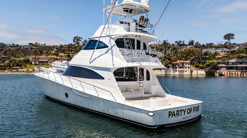 Slide: The Image of Aft View with Skybridge This image showcases the elegant aft view of the 2019 Viking 80 Skybridge, named PARTY OF FIVE. The vessel features a spacious cockpit and an impressive skybridge equipped with modern navigation systems. The sleek design and smooth lines highlight Viking' - 6478768