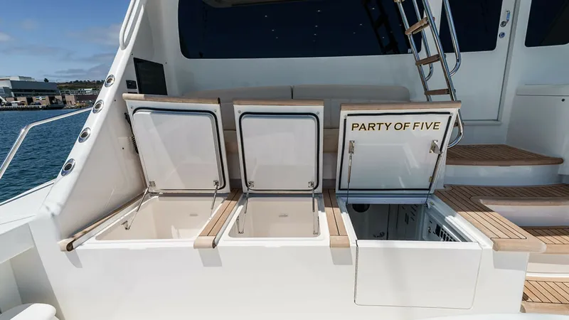 Slide: The Image of Aft Deck with Storage Compartments This image showcases the aft deck of the 2019 Viking 80 Skybridge, featuring spacious storage compartments. The sleek design and high-quality materials are evident in the polished finish and teak decking. The neatly integrated steps and ladder provide eas - 6478750