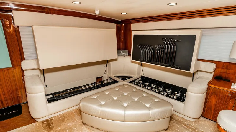 Slide: The Image of Salon with Hidden Rod Storage This elegant salon features a sophisticated hidden entertainment system, seamlessly integrated into the plush seating area. The cabinetry is adorned with high-gloss wood finishes, adding a touch of luxury to the space. Recessed lighting complements the co - 6613312