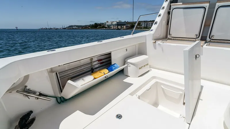Slide: The Image of Spacious Aft Deck with Storage The aft deck of the Viking 80 Skybridge, PARTY OF FIVE, features ample storage compartments, perfect for organizing equipment and supplies. The clean, white finish provides a sleek, modern look, while the open space allows for easy movement and accessibil - 6478760