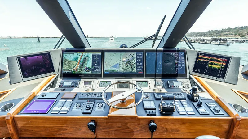 Slide: The Image of Skybridge Helm Station The helm station of the Viking 80 Skybridge offers a state-of-the-art navigation experience. It features a comprehensive array of multi-function displays, providing critical navigation and system information at a glance. The luxurious wood finish and ergo - 6478741