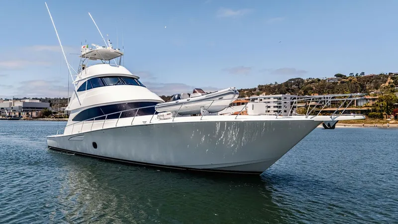 Slide: The Image of Starboard Bow View with Tender This image showcases the starboard side of the 2019 Viking 80 Skybridge, 'PARTY OF FIVE,' highlighting its sleek bow design and spacious foredeck. A tender is prominently positioned on the deck, ready for easy deployment. The vessel's elegant lines and mo - 6478772