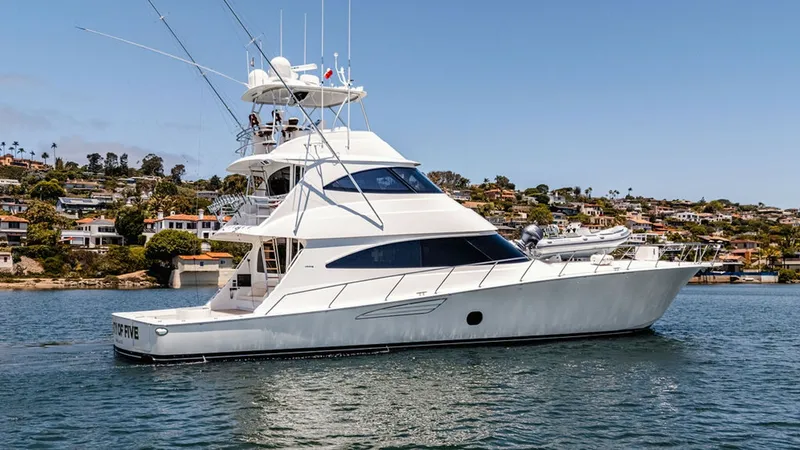 Slide: The Image of Starboard View of Viking 80 Skybridge This image showcases the sleek profile of the 2019 Viking 80 Skybridge, 'PARTY OF FIVE,' highlighting its impressive stature and elegant design. The vessel's expansive flybridge offers excellent visibility and is ideal for navigation, equipped with advanc - 6478770
