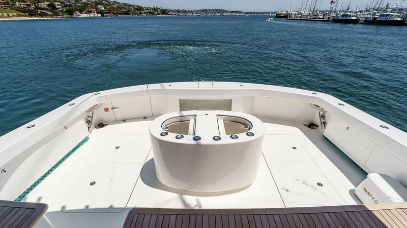 Slide: The Image of Spacious Aft Deck with Rod Holders The aft deck of the 2019 Viking 80 Skybridge 'PARTY OF FIVE' offers an expansive area perfect for both relaxation and sportfishing. Featuring a central livewell with integrated rod holders, this space is designed for serious anglers. The teak decking adds - 6478762