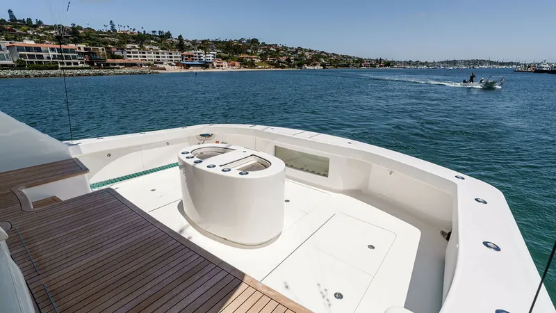 Slide: The Image of Spacious Aft Deck with Teak Flooring The aft deck of the 2019 Viking 80 Skybridge, PARTY OF FIVE, boasts a luxurious teak floor, offering both style and durability. The central console provides convenient access to controls, enhancing functionality while maintaining a sleek appearance. Surro - 6478763