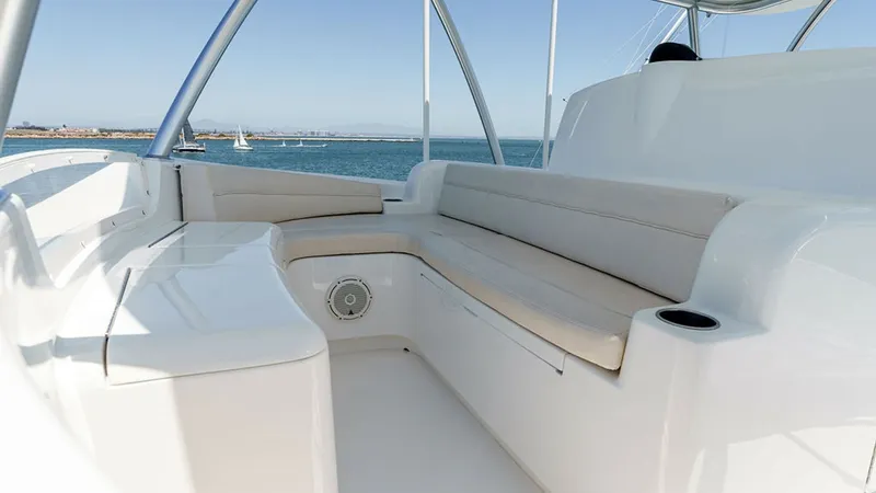 Slide: The Image of Skybridge Lounge Seating Area The Skybridge on the 2019 Viking 80 features a spacious lounge area with plush, curved seating, perfect for enjoying panoramic ocean views. The sleek design and high-quality materials provide both comfort and style, while integrated cup holders add conven - 6478749