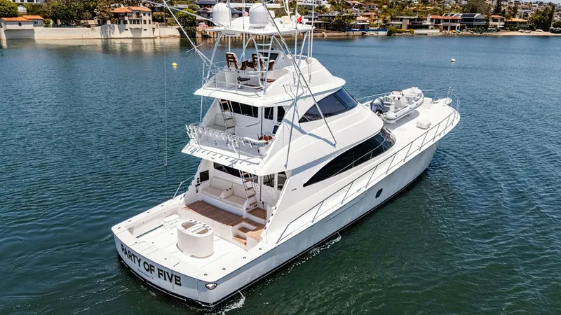 Slide: The Image of Aft Deck and Skybridge View This image showcases the aft deck and impressive skybridge of the 2019 Viking 80 Skybridge, 'PARTY OF FIVE.' The spacious aft deck features ample seating for relaxation and entertainment, while the skybridge offers commanding views and a well-equipped hel - 6478769