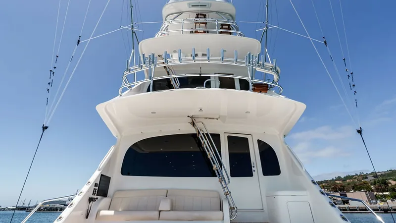 Slide: The Image of Aft Deck and Skybridge View This stunning view showcases the aft deck of the 2019 Viking 80 Skybridge, featuring comfortable seating and sleek design elements. The skybridge towers above, offering a commanding vantage point and equipped with state-of-the-art navigational equipment. - 6478738