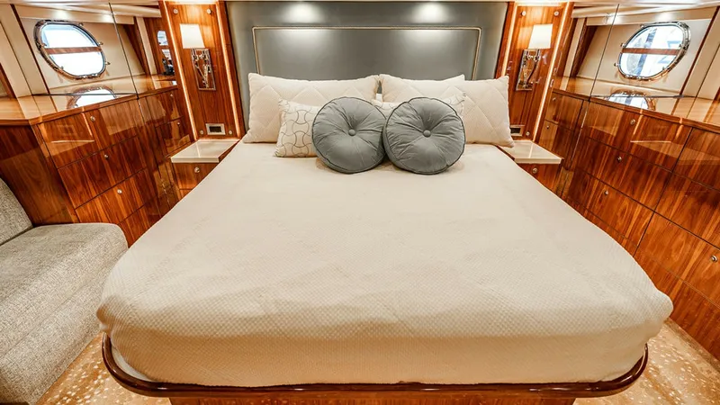 Slide: The Image of Luxurious Master Stateroom The master stateroom of the 2019 Viking 80 Skybridge exudes elegance with its plush bedding and high-gloss wood finishes. Ambient lighting and portside windows create a warm, inviting atmosphere, while ample storage space enhances functionality. This sere - 6478716